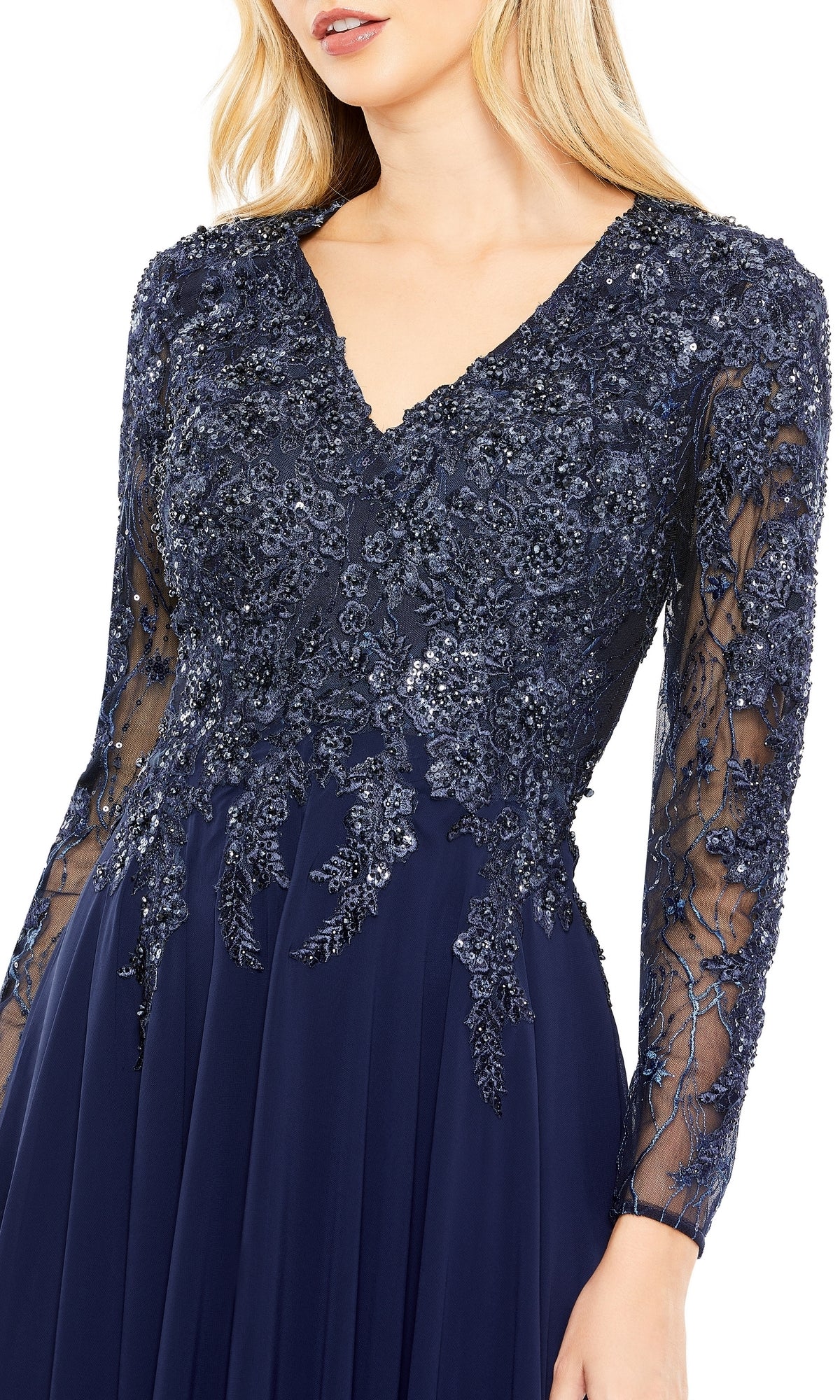Woman in the Mac Duggal 20388 long sleeve special occasion dress, featuring navy blue lace and sequin embroidery on the bodice with sheer sleeves—ideal for a sophisticated evening event.